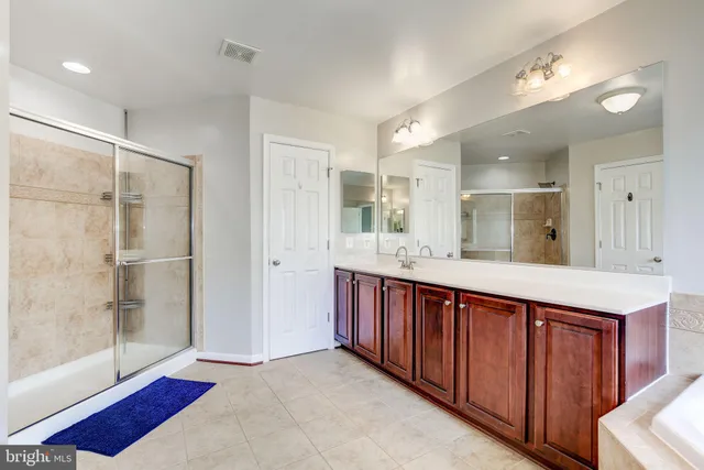 a bathroom with a double vanity sink and a mirror