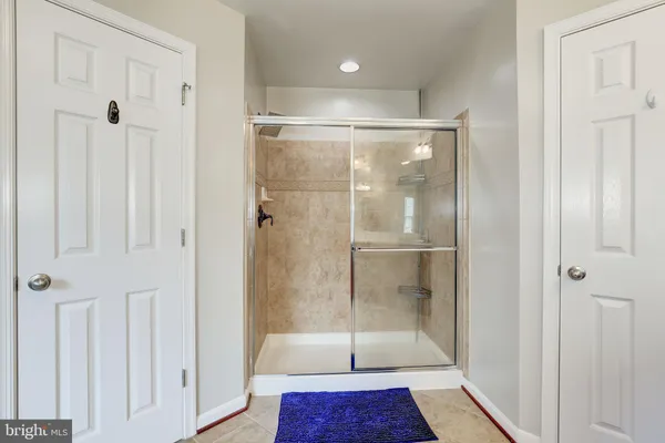 a bathroom with a glass shower door
