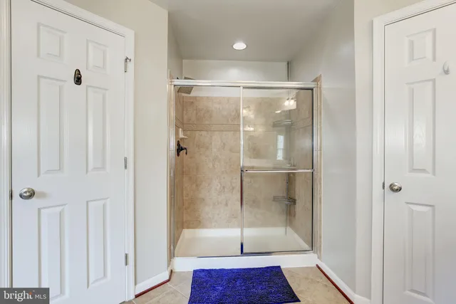 a bathroom with a glass shower door