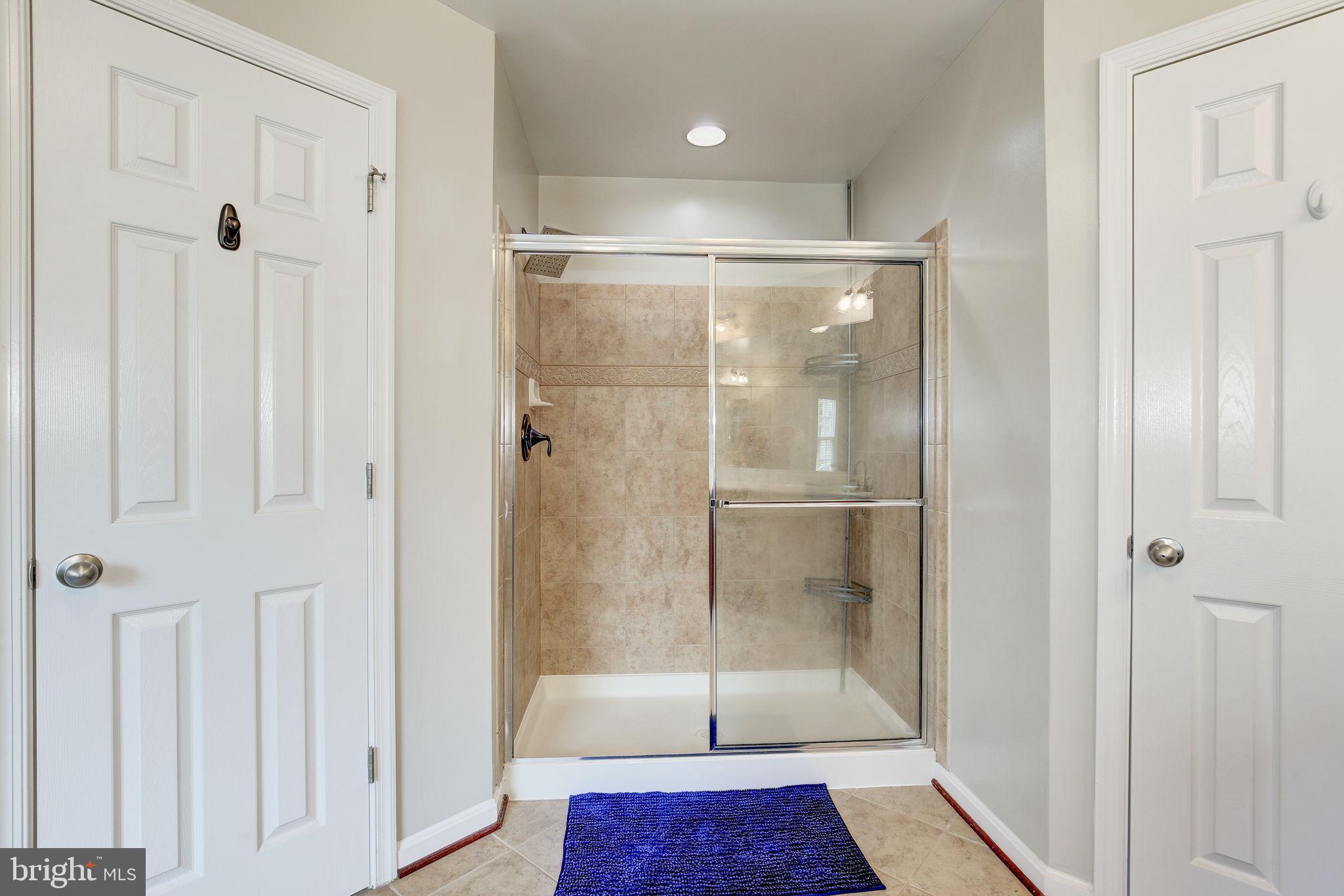 2311 Whitley Road Baltimore, MD 21209 - Photo 28 of 47 a bathroom with a glass shower door