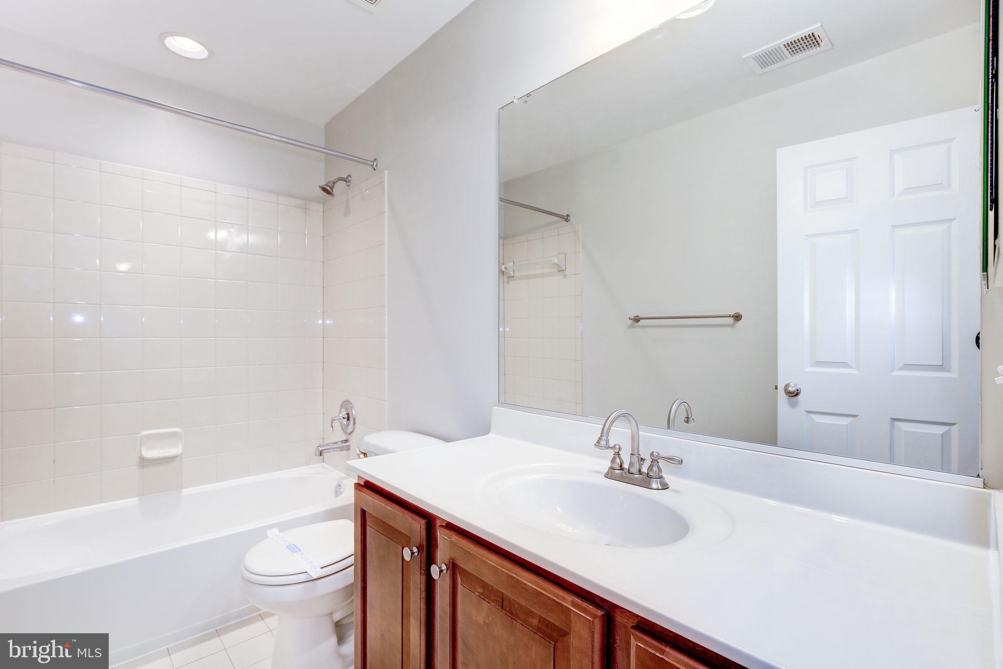 2311 Whitley Road Baltimore, MD 21209 - Photo 38 of 47 a bathroom with a sink a toilet a shower and a mirror