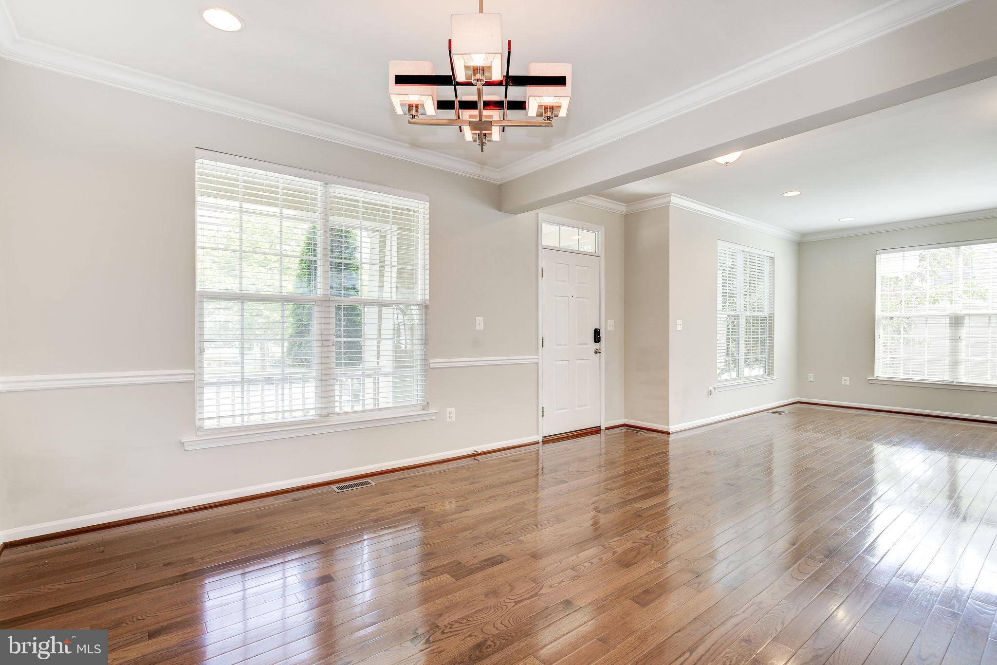 2311 Whitley Road Baltimore, MD 21209 - Photo 7 of 47 a view of an empty room with wooden floor and a window