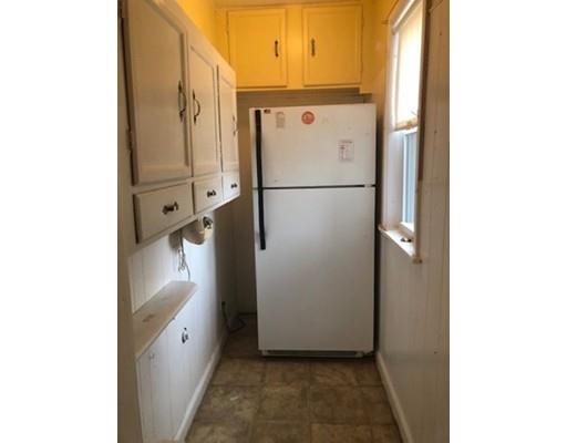 113 King Philip Road Worcester, MA 01606 - Photo 7 of 16 a white refrigerator freezer sitting in a kitchen