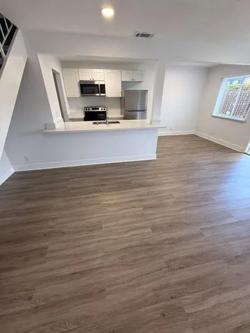 a view of a kitchen with a sink and a microwave