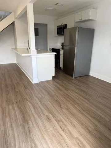 a kitchen with stainless steel appliances a refrigerator and a stove