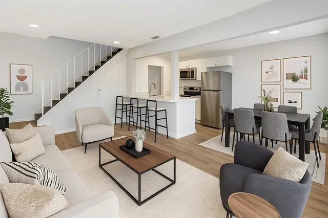 a living room with furniture kitchen view and a dining table