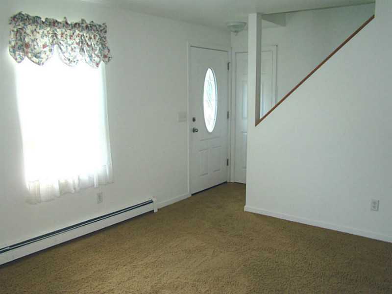 23 Buck Road Middletown, RI 02842 - Photo 4 of 21 Living Room. Front Door and staircase to 2nd floor
