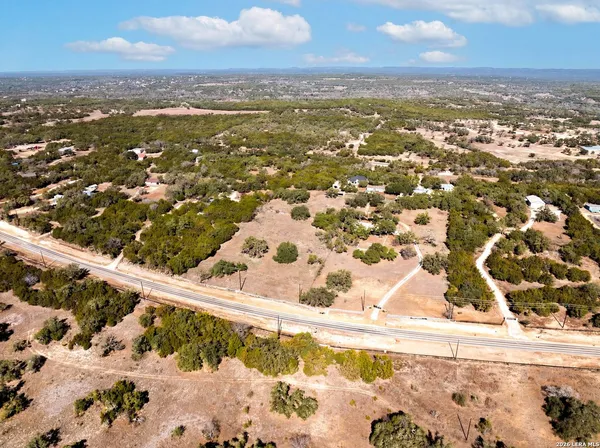 an aerial view of residential houses with city view