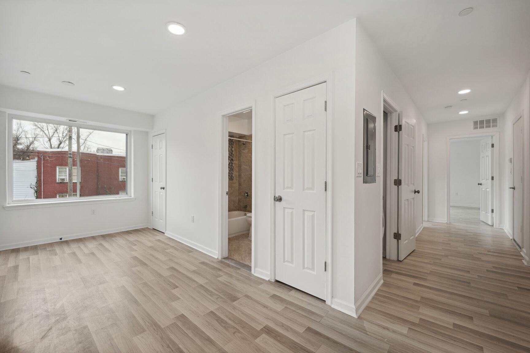 1642 16th Street Southeast, Unit 3 Washington, DC 20020 - Photo 6 of 22 a view of an empty room with wooden floor and a window
