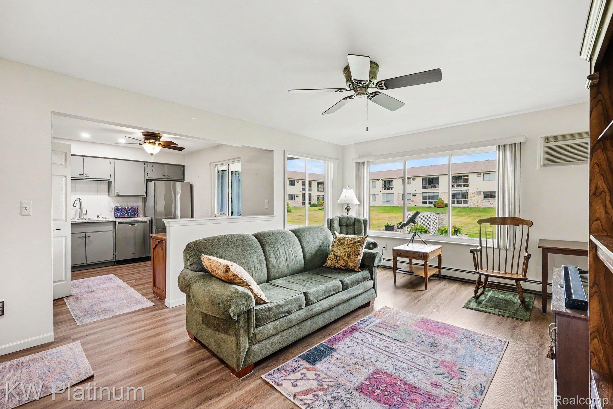 1700 River Road, Unit 6 Marysville, MI 48040 - Photo 6 of 32 Open-concept living area featuring wood-finish flooring, a ceiling fan, and large windows