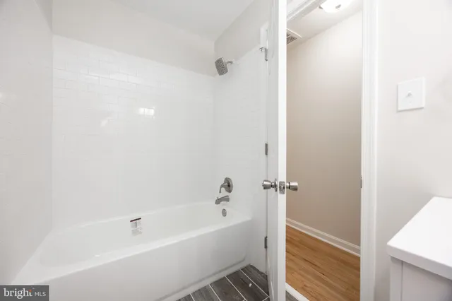 a white bath tub sitting next to a white sink