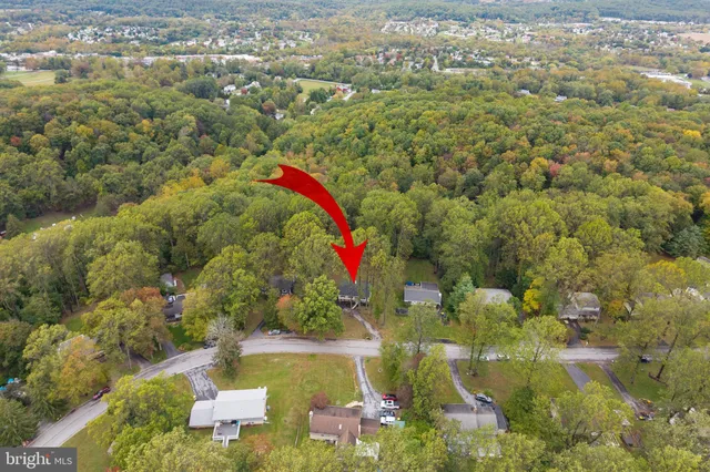 an aerial view of residential house with outdoor space and swimming pool