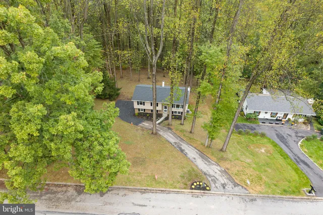 a view of a house with a yard chairs and table