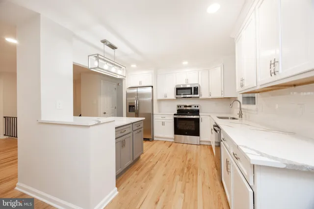 a kitchen with a sink stove and refrigerator