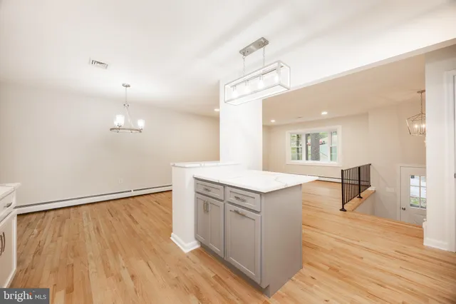 a kitchen with a wooden floor and a refrigerator