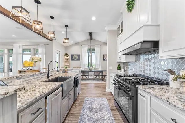 a large kitchen with a table and chairs