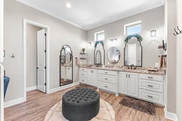 a spacious bedroom with a bed and a flat screen tv