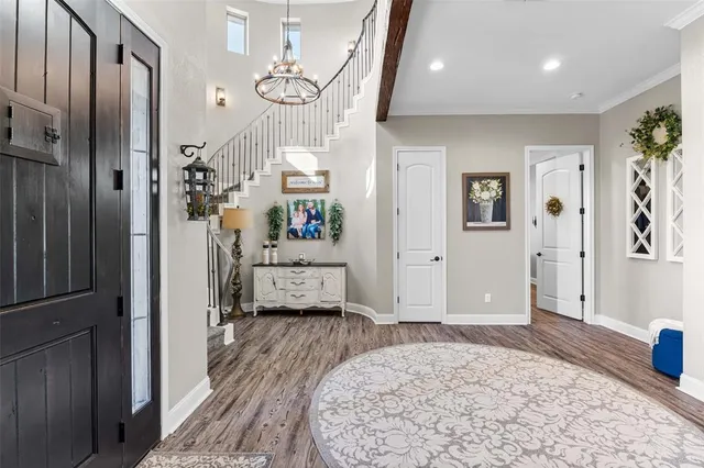a walk in closet with wooden floor