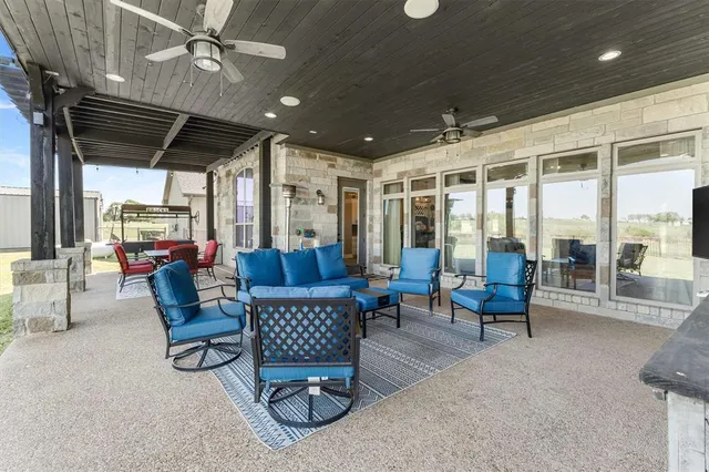 a bathroom with a granite countertop sink a toilet and shower