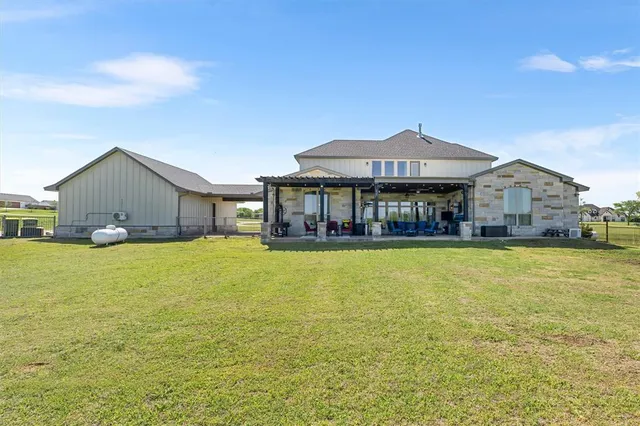 a living room with furniture a flat screen tv and a floor to ceiling window
