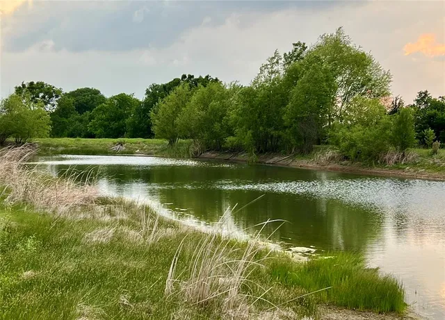 a front view of a house with swimming pool having outdoor seating