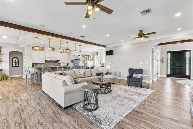 a living room with furniture and wooden floor
