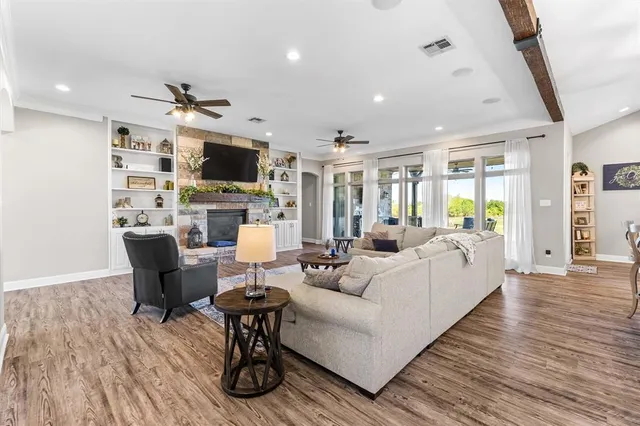 a living room with fireplace furniture and a flat screen tv