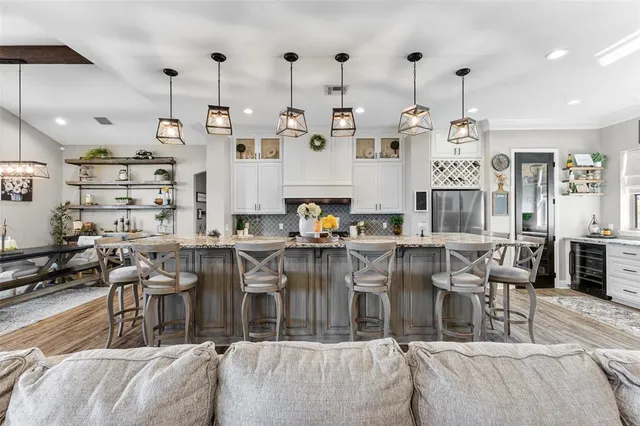 a living room with lots of furniture and kitchen view