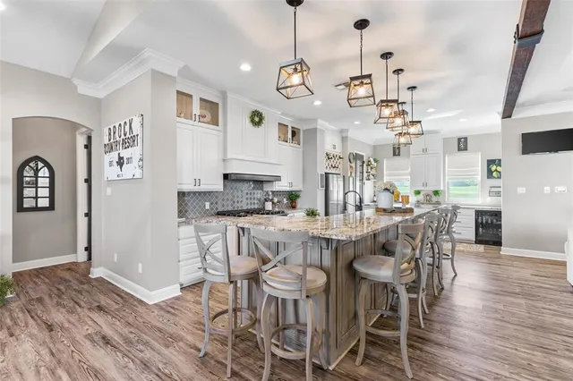 a large kitchen with a table and chairs