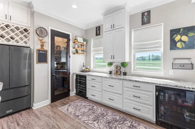 a kitchen with granite countertop a refrigerator and a stove top oven