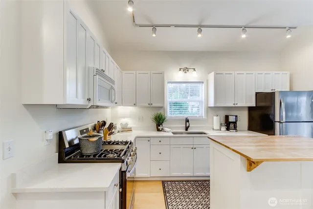 a kitchen with a sink stove and cabinets