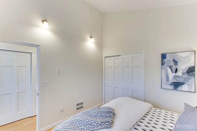 a bedroom with a bed and a window