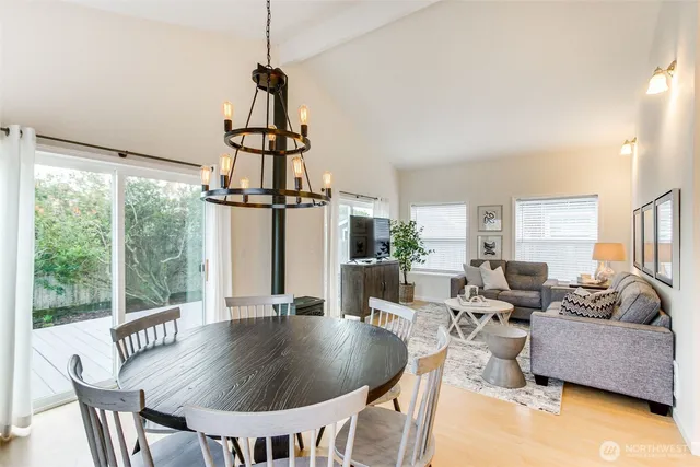 a living room with furniture a window and a chandelier