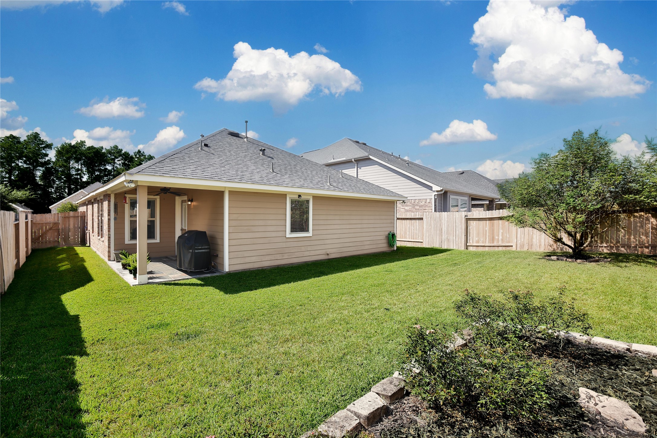 214 Pleasant Hill Way Conroe, TX 77304 - Photo 4 of 43 The backyard is a great size for outdoor fun with landscaping beds added.