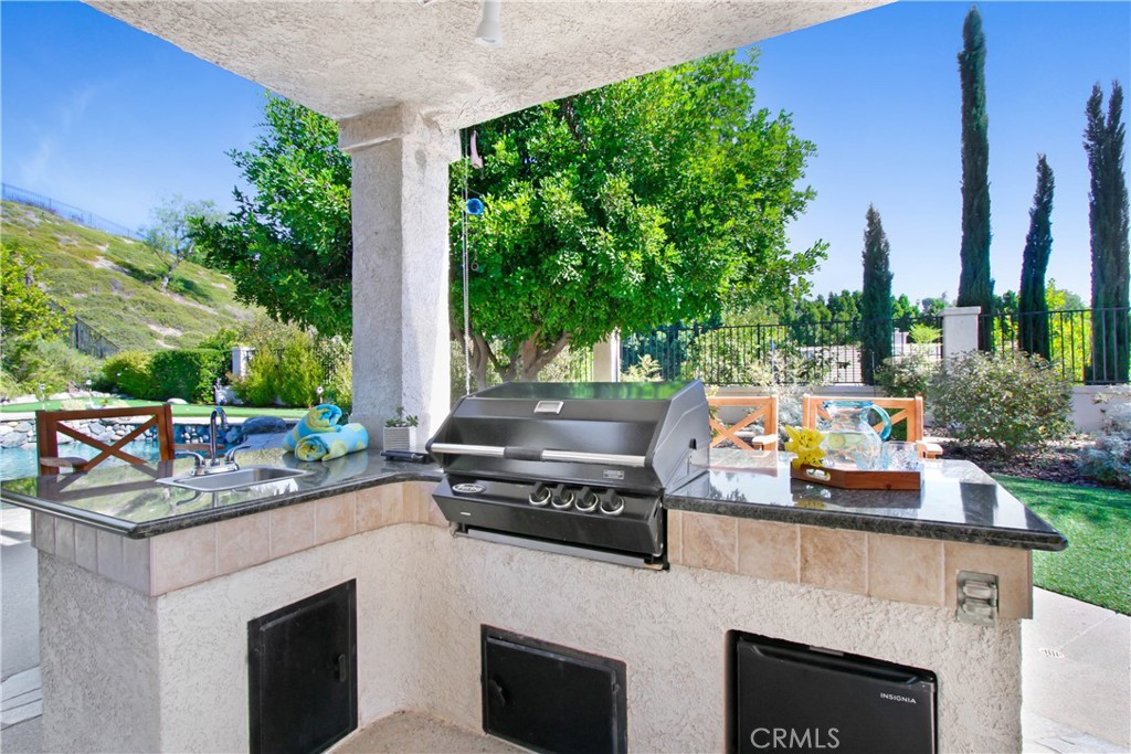 12036 Wood Ranch Road Granada Hills, CA 91344 - Photo 46 of 55 BBQ island with sink and small refrigerator