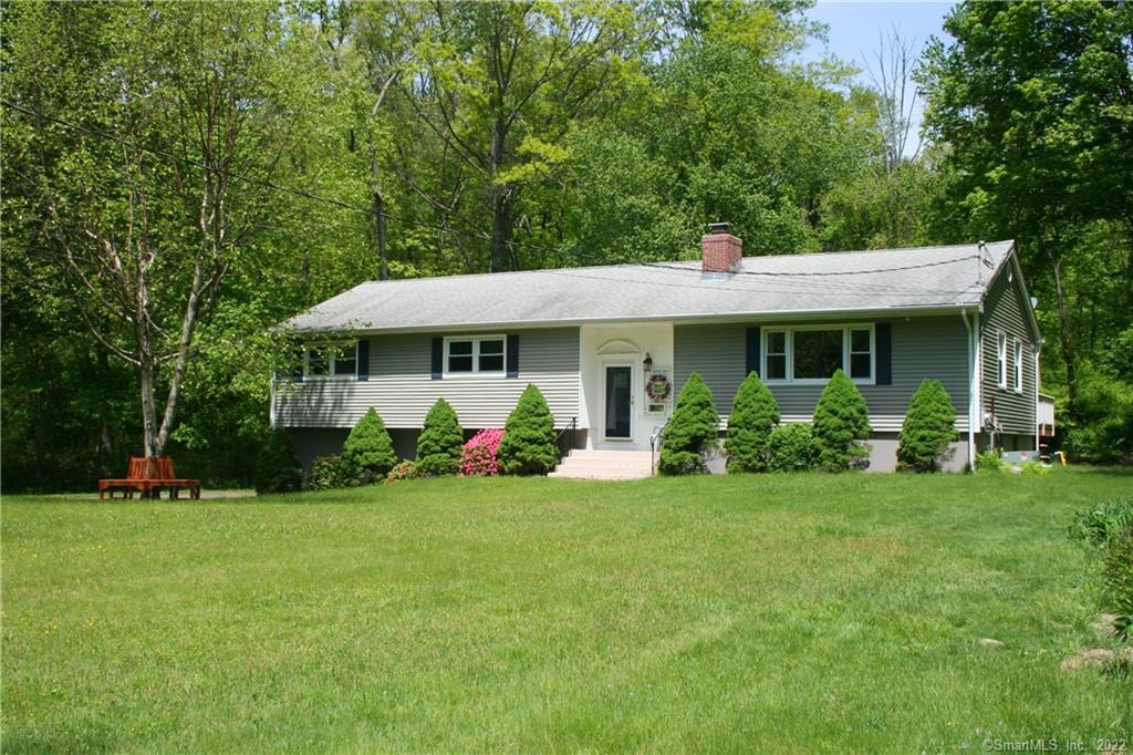 a view of a house with a yard porch and sitting area