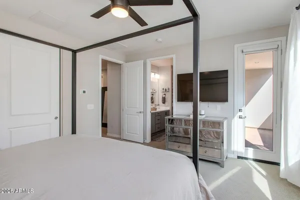 a bedroom with a bed and a television