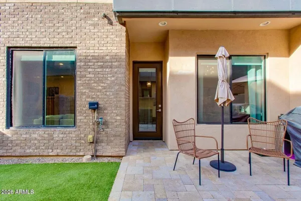 a view of house with backyard and outdoor seating