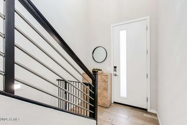 a view of staircase with white walls and a window