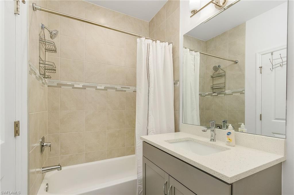 7596 Morgan Way Naples, FL 34119 - Photo 20 of 35 a bathroom with a sink and a mirror