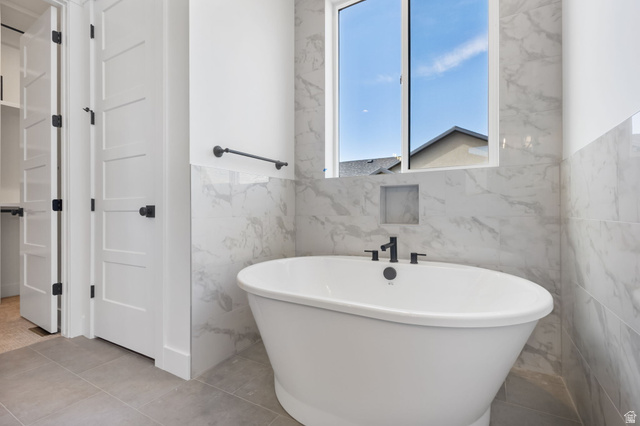 692 East Mountain Road North Ogden, UT 84414 - Photo 7 of 17 Freestanding soaking tub with matte black fixtures, set against large format marble-look wall tiles