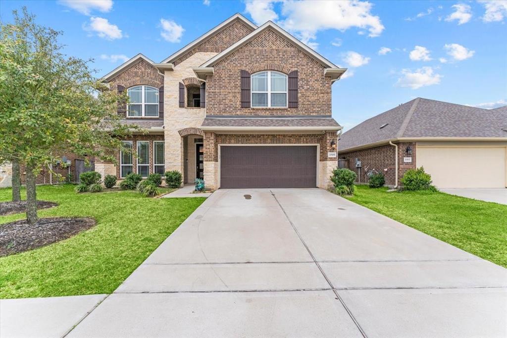 20106 Kyle Canyon Drive Cypress, TX 77433 - Photo 1 of 49 a front view of a house with a yard and garage