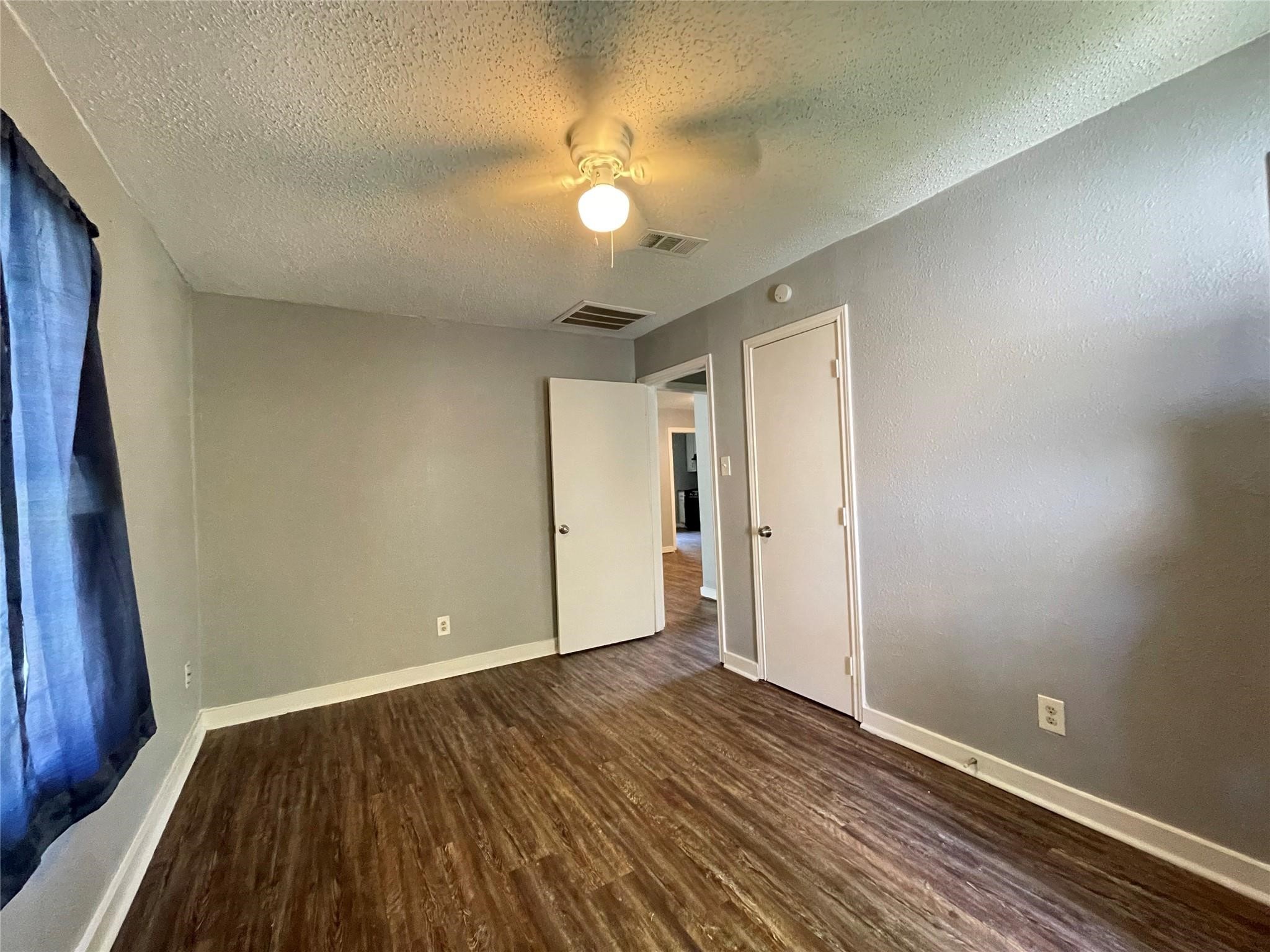 5213 Anzio Road Houston, TX 77033 - Photo 13 of 20 a view of an empty room with wooden floor