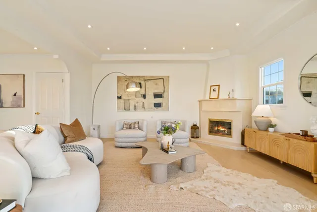 a living room with furniture and large windows