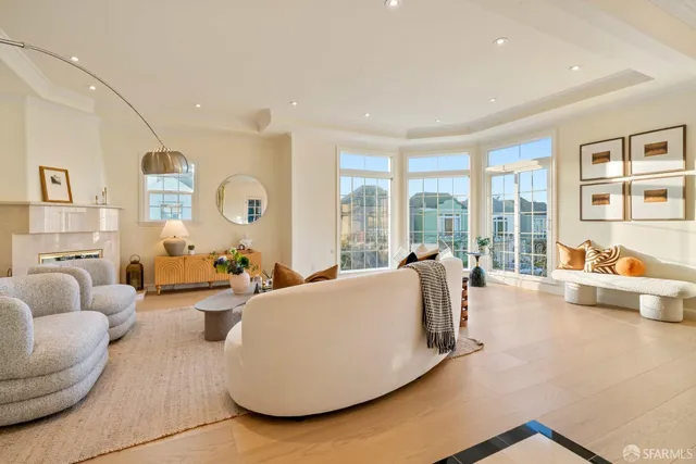 a living room with furniture and a floor to ceiling window