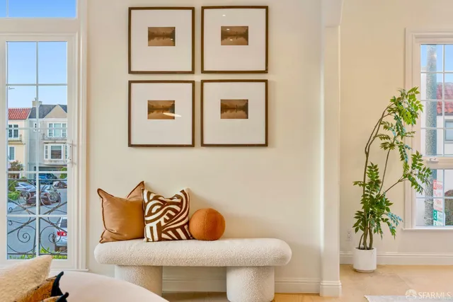 a living room with furniture and a potted plant