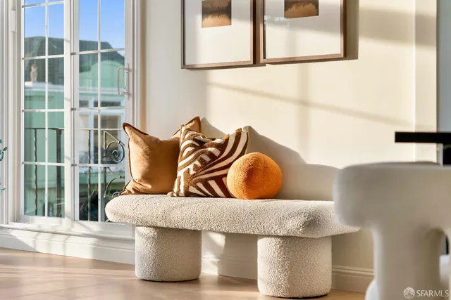a living room with furniture and large windows
