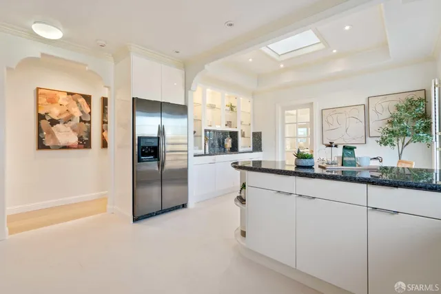 a kitchen with white cabinets and white appliances