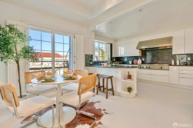 a kitchen with stainless steel appliances granite countertop a stove and a white cabinets