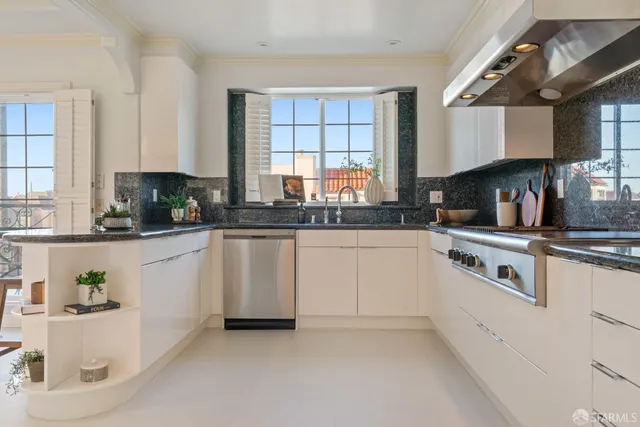 a kitchen with stainless steel appliances granite countertop a sink and a refrigerator